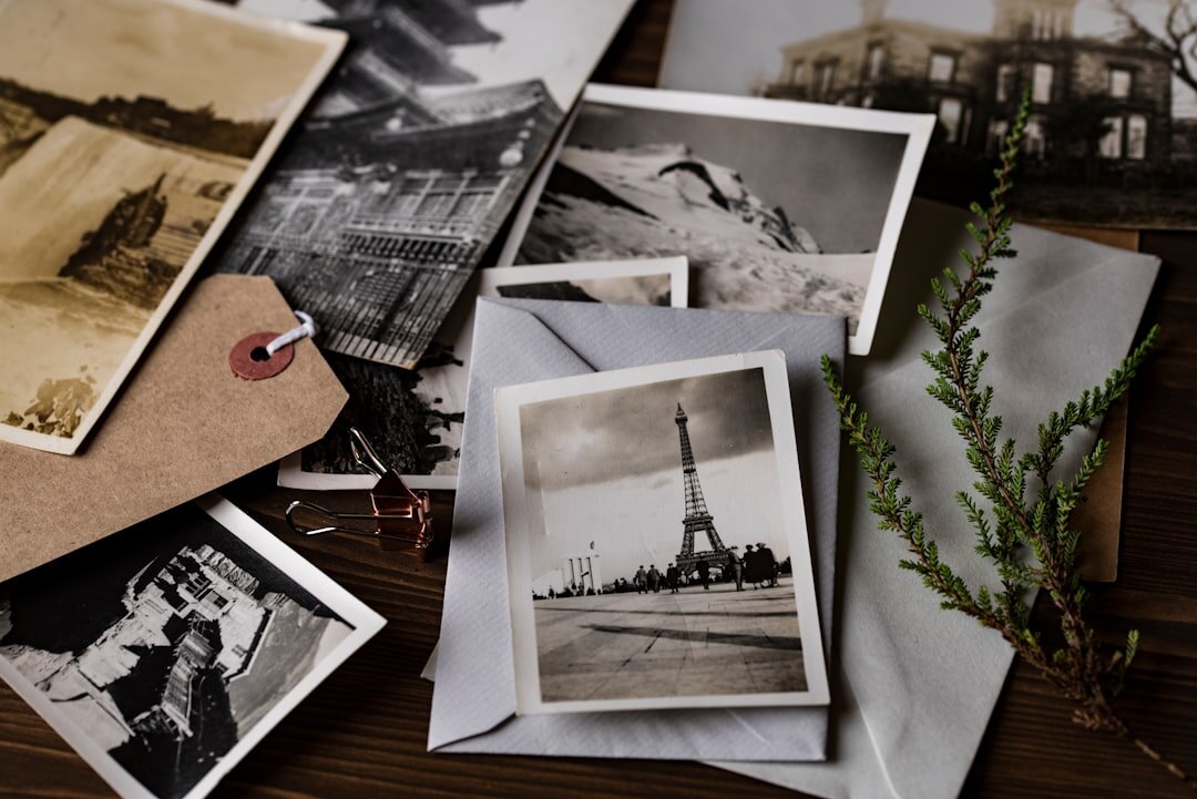 Photography archive with printed black and white photographs on a wooden table